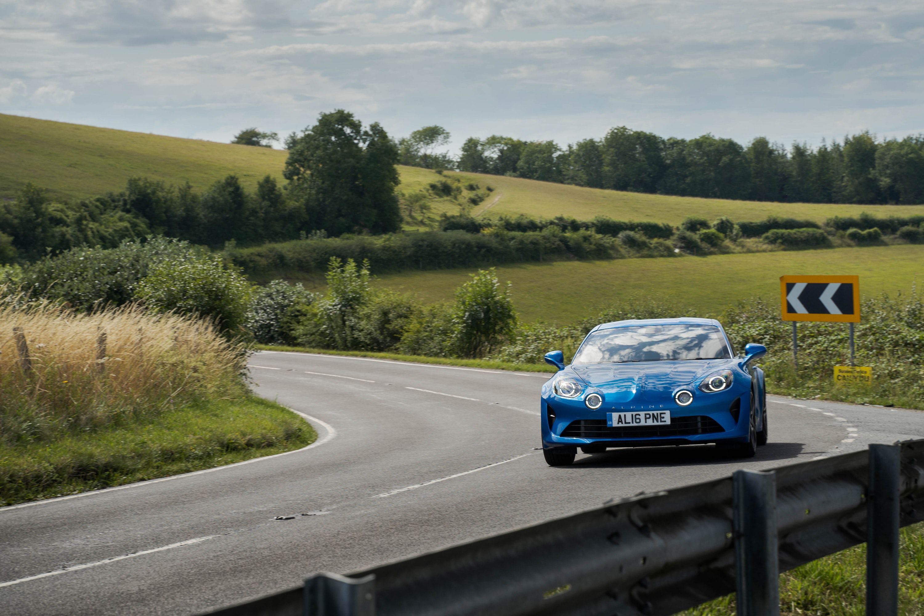 Alpine A110 driving on a road